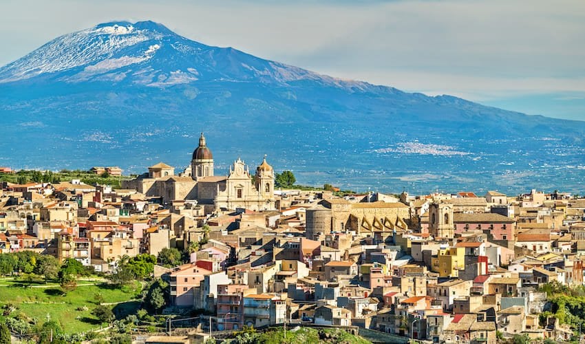 Village sicilien avec le volcan Etna à l'horizon.