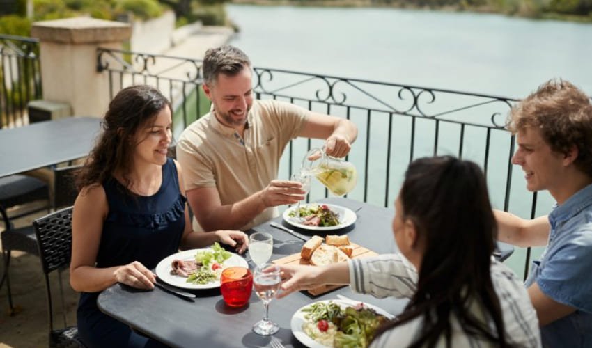 Une famille appréciant un repas lors d'un week-end prolongé au Village Pont Royal en Provence dans le Lubéron